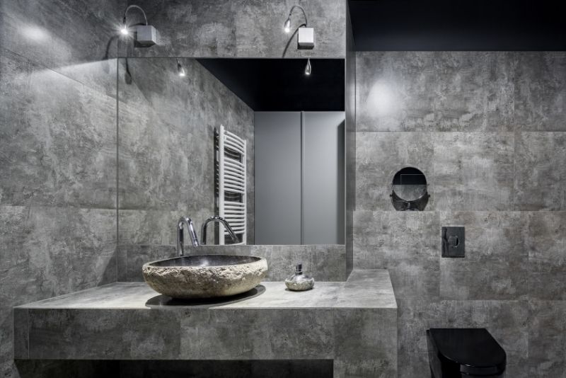 unique bathroom tiled walls and rock texture sink