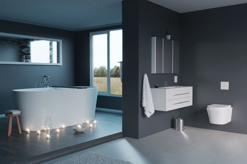 a bath tub with candles on the floor