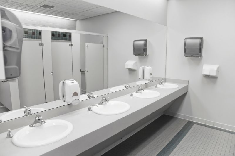 commercial bathroom space renovations putting large mirror