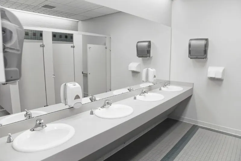 commercial bathroom space renovations putting large mirror